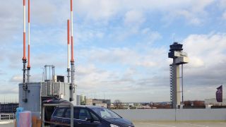 Rohde & Schwarz installation vehicle during RASUM 8,33 roll-out in front of a radio site at Frankfurt Airport. (Image: Rohde & Schwarz) 